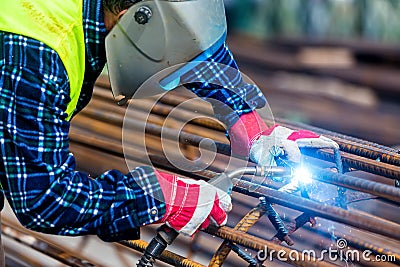 Welder worker welding metal by electrode Stock Photo