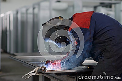 Welder working on factory, Welding Work. Erecting Technical Steel Industrial Craftsman on plant. Stock Photo