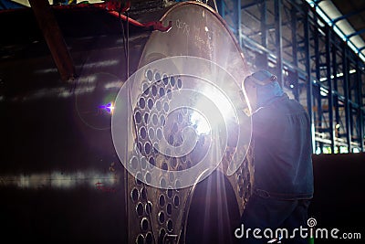 Welder working in industrial factory Stock Photo