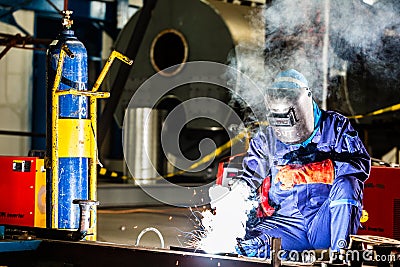 Welder working in industrial factory Stock Photo