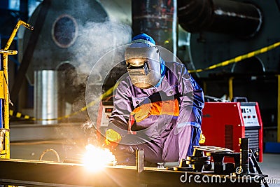 Welder working in industrial factory Stock Photo