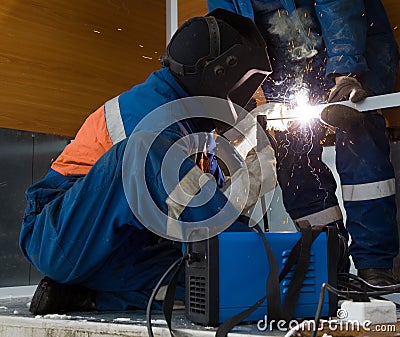 Welder working with a metal structure Stock Photo