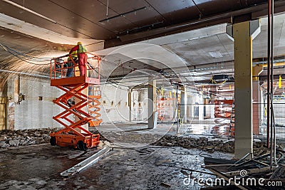 Welders on Scissor Lift at Construction site Stock Photo