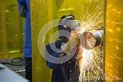 The welding craftsman grinding the steel tube Stock Photo