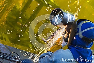 The welding craftsman grinding the steel tube Stock Photo