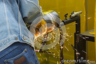 The welding craftsman grinding the steel tube Stock Photo