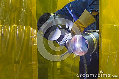 The welding craftsman welding the steel tube Stock Photo