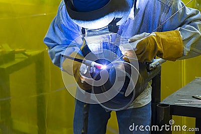 The welding craftsman welding the steel tube Stock Photo