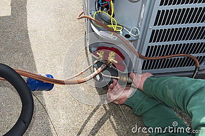 Welding, Install Central Air Conditioner AC Unit Stock Photo