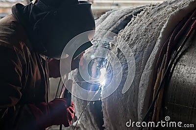 Welding large diameter pipes with pre-heated flexible ceramic heating elements Stock Photo