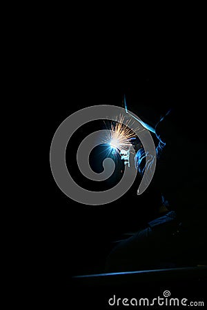 Welding with a MIG in the dark Stock Photo