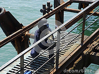 Welding operator near the sea Stock Photo