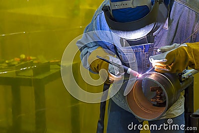 The welding operator welding the tube Stock Photo