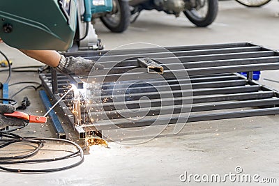 The welding operator welding the tube Stock Photo