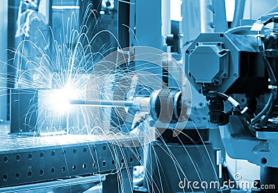 Welding robot manipulator on production line close - up blue toning Stock Photo