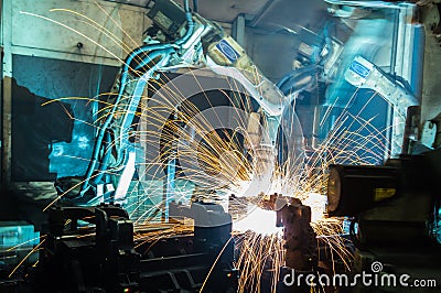 Welding robots movement in a car factory Stock Photo
