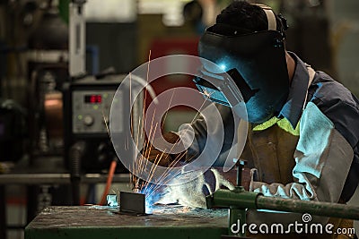 Welding worker in factory Stock Photo