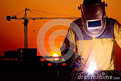 Welding worker welding steel structure with construction crane Stock Photo