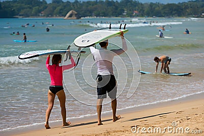 WELIGAMA, SRI LANKA - JANUARY 09 2017: Unidentified couple surfing on a large wave on Weligama beach on the coast of Indian ocean Editorial Stock Photo