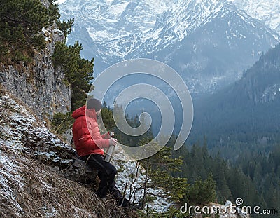 Well built mountain guide having rest at astonishing winter rocky landscape background Stock Photo