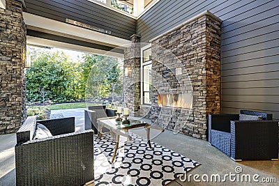 Well designed covered patio boasts stone fireplace Stock Photo