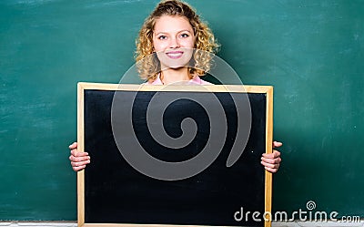 Well Done is Our Duty. woman teacher at blackboard. copy space. here is your advertisement. informations board Stock Photo