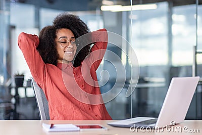 Well done woman completed work project, businesswoman smiling relaxed and looking at laptop screen, female worker with Stock Photo