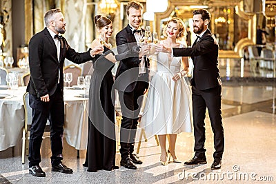 Well-dressed people celebrating New Year indoors Stock Photo