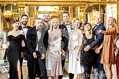 Well-dressed people celebrating New Year indoors Stock Photo