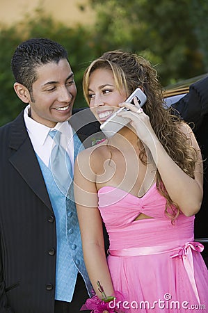 Well-dressed young couple using cell phone Stock Photo