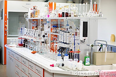 Well equipped chemical laboratory with glassware, pipettes, flasks and bottles. The workplace for research work Editorial Stock Photo