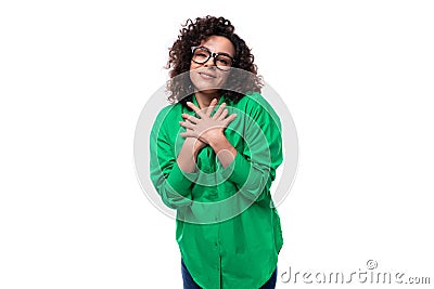 well-groomed young female marketing employee with black hair dressed in a green shirt on a white background with copy Stock Photo
