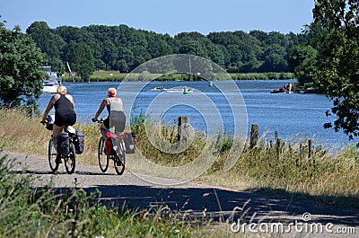 Well, Holland - 06/30/2018: Tourist couple cycling Editorial Stock Photo