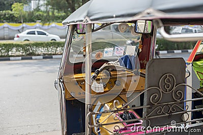 Well known and famous local taxi in Thailand, Tuk-Tuk, parking nearby tourist place, waiting for passengers asking for a ride. Stock Photo