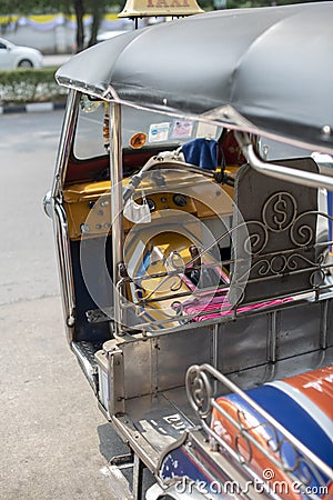 Well known and famous local taxi in Thailand, Tuk-Tuk, parking nearby tourist place, waiting for passengers asking for a ride. Stock Photo