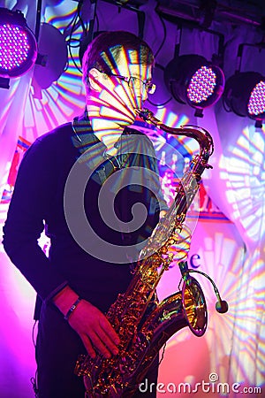Well-known pop and jazz musician Alexander Mazur plays a sax solo Editorial Stock Photo