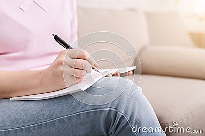 Well organized senior woman with notebook, writing to-do-list Stock Photo