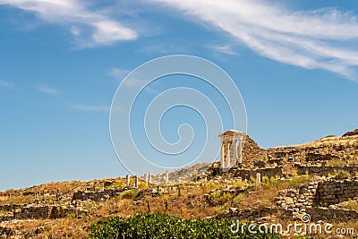 Well preserved Temple of Isis on Delos Island located on the hill above the ancient city with other ruins and blue sky Stock Photo