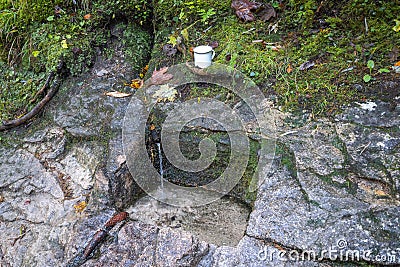 The Well with running water carved into the rock Stock Photo