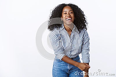 Wellbeing happiness people concept. Entertained charming friendly carefree african american woman curly-haired bending Stock Photo