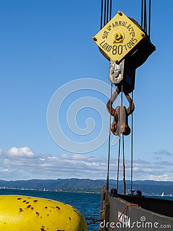 Heavy lifting big block and tackle pulley with wire rope on city waterfront Editorial Stock Photo