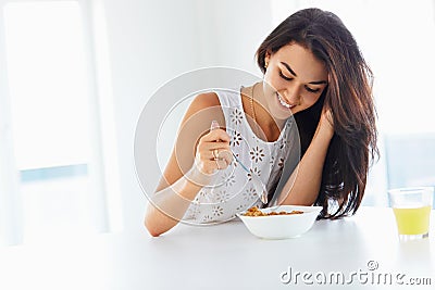 Wellness concept. Woman eating cereal and smiling. Healthy break Stock Photo