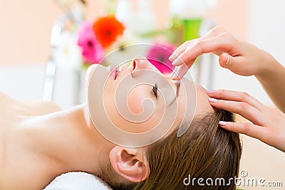 Wellness - woman getting head massage in Spa Stock Photo