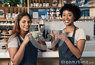 Were geeks about coffee. Portrait of two young women drinking coffee together while working in a cafe. Stock Photo