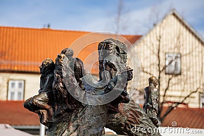 Wernigerode, Saxony-Anhalt, Germany, 29 October 2022: Water fountain in the form of ball with tree trunk and sculptures sitting Editorial Stock Photo