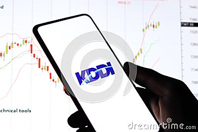 West Bangal, India - October 09, 2021 : KDDI logo on phone screen stock image. Editorial Stock Photo