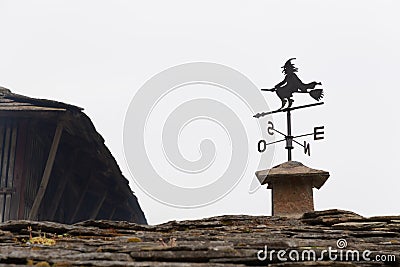 West facing metal weather vane with a witch mounted on a broom Stock Photo