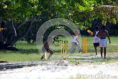 West Indies, Caribbean, Antigua, St Mary, Ffryes Beach, Youngsters Playing Cricket on the Beach Editorial Stock Photo