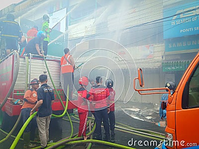 West Kalimantan,Indonesia - 8 Juni 2019,4 houses burned down and the Firefighters extinguish a raging fire in a indonesia house Editorial Stock Photo