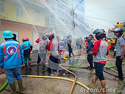 West Kalimantan,Indonesia - 8 Juni 2019,4 houses burned down and the Firefighters extinguish a raging fire in a indonesia house Editorial Stock Photo